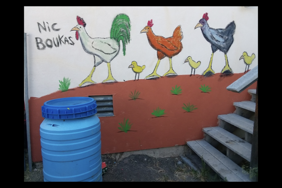 4 of 4, Painting on a building containing chickens trodding in the desert.