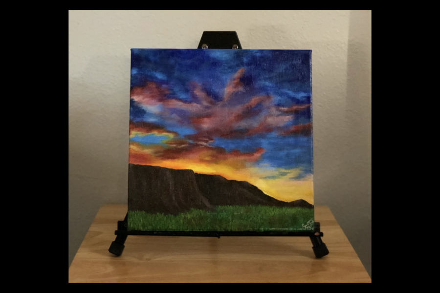 1 of 4, A landscape painting, supported by a pedestal, of the sun setting behind a mesa.